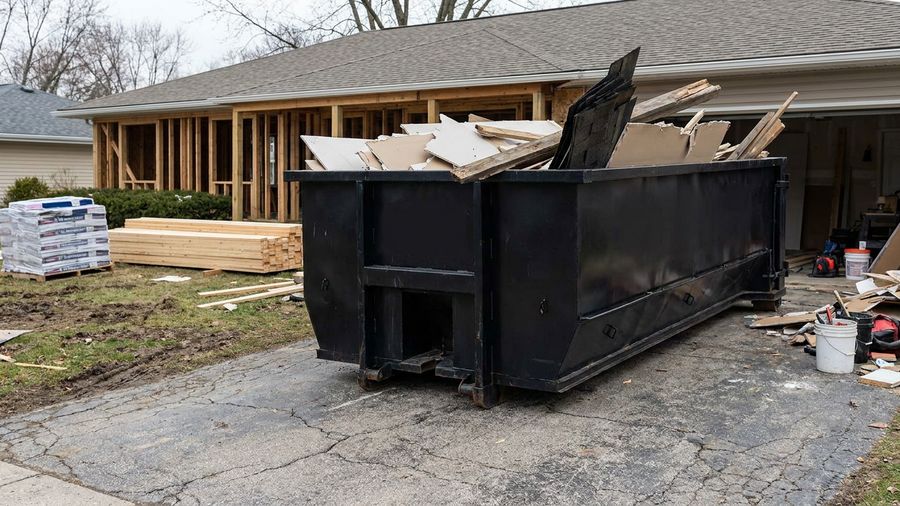 20-yard roll-off dumpster beside a home renovation